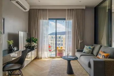 a living room with a couch and a table at The Title Legendary Vintage Gloss in Bang Tao Beach