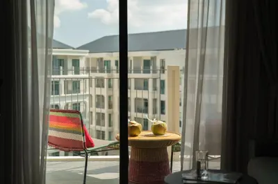 a room with a view of a building from a window at The Title Legendary Vintage Gloss in Bang Tao Beach