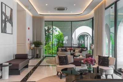 a lobby with couches and tables and windows at The Title Legendary Vintage Gloss in Bang Tao Beach