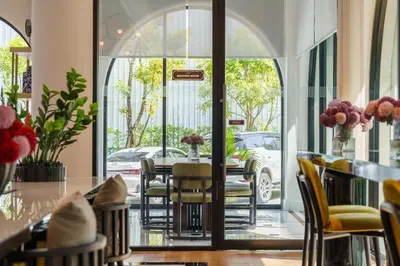 a dining room with a table and chairs at The Title Legendary Vintage Gloss in Bang Tao Beach