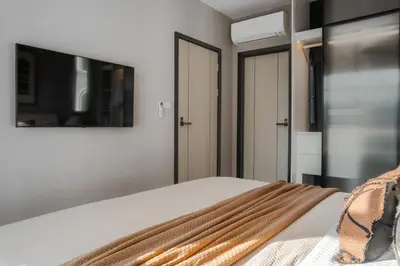 a bedroom with a bed and a flat screen tv at The Title Legendary Nature Flow in Bang Tao Beach