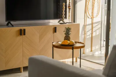 a pineapple sitting on a table next to a tv at The Title Legendary Nature Flow in Bang Tao Beach
