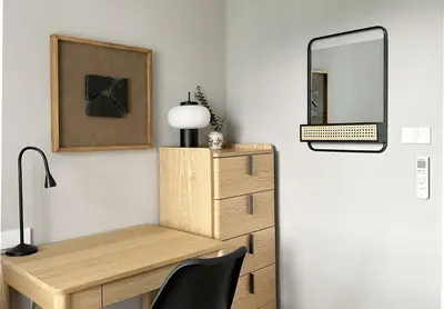 a desk with a lamp and a mirror on a wall at The Title Legendary Nature Flow in Bang Tao Beach