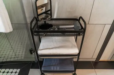 a shelf in a room with a sink and a mirror at The Title Legendary Nature Flow in Bang Tao Beach