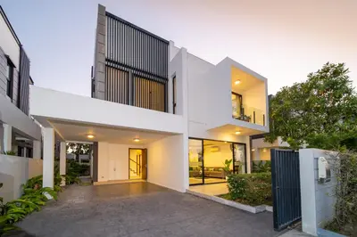 an exterior view of a white house with a courtyard at Laguna park 5bedroom private pool villa in Laguna Phuket