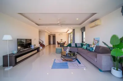 a living room with a couch and a flat screen tv at Laguna park 5bedroom private pool villa in Laguna Phuket