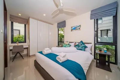 a bedroom with two beds and a desk and windows at Laguna park 5bedroom private pool villa in Laguna Phuket