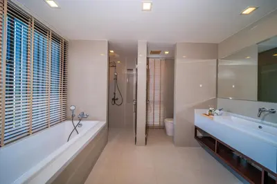 a bathroom with a tub and a toilet and a sink at Laguna park 5bedroom private pool villa in Laguna Phuket