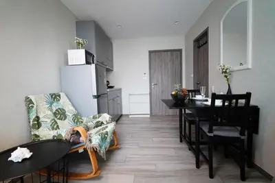 a kitchen and dining room with a table and a refrigerator at Title - Comfortable 1BR Tropical Retreat in Nai Yang Beach