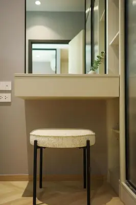 a stool sitting under a mirror in a bathroom at Bangtao The Title Legendary by Phuket Sabay Rent G201 in Bang Tao Beach