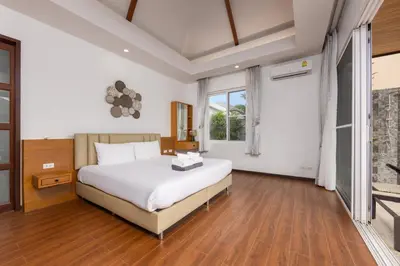 a bedroom with a white bed and a large window at Villa Hemi 2BR Modern Thai Style with Private Pool in Rawai Beach