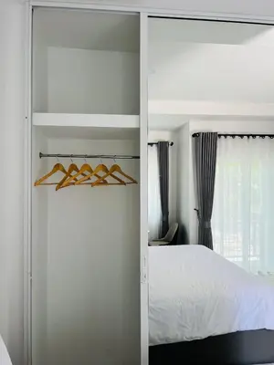 a bedroom with a white bed and a window at Sarona House 3 in Ban Thalat Choeng Thale