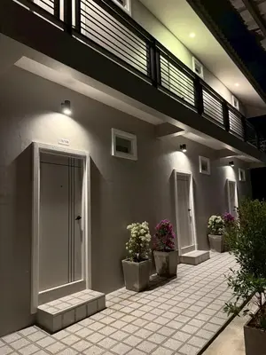 a building with potted plants on the side of it at Sarona House 3 in Ban Thalat Choeng Thale