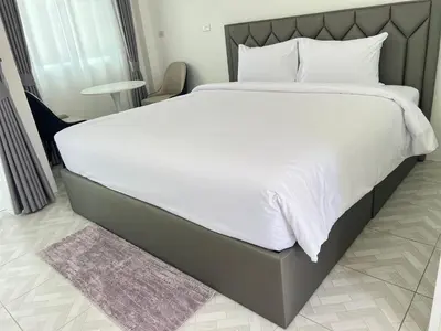 a large bed with white sheets and pillows at Sarona House 3 in Ban Thalat Choeng Thale