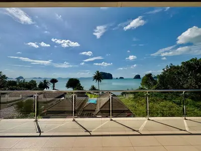 a view of the ocean from a balcony at Sunset bay view villa krabi in Ban Khao Thong