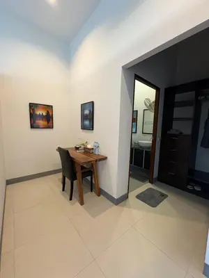 a dining room with a table and a bedroom at Sunset bay view villa krabi in Ban Khao Thong