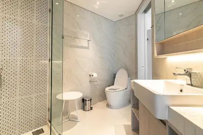 a bathroom with a toilet and a sink and a shower at Cassia Residence by Villacarte in Laguna Phuket
