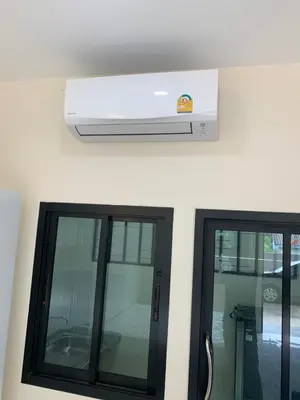 two windows in a room with a air conditioner at ZAMZAM House in Thalang