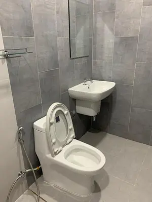 a bathroom with a toilet and a sink at ZAMZAM House in Thalang