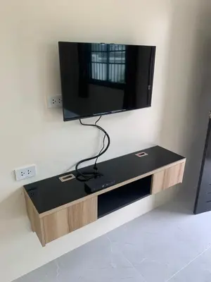a flat screen tv hanging on a wall at ZAMZAM House in Thalang