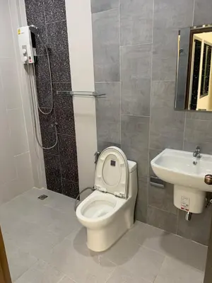 a bathroom with a toilet and a sink at ZAMZAM House in Thalang