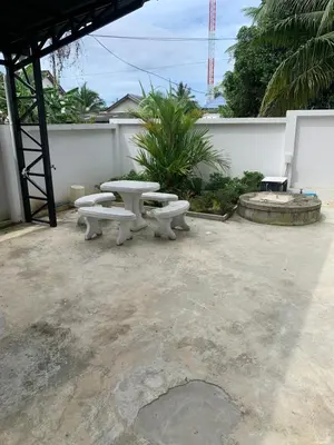 a group of picnic tables sitting on a patio at ZAMZAM House in Thalang