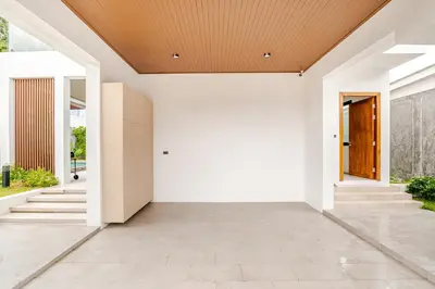 an open hallway with white walls and a wooden ceiling at 3BR Pool Villa JAAI in Ban Saiyuan (1)