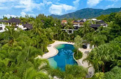 an aerial view of a resort with a pool and palm trees at C254 Condo 2BR Pool View Short Walk to Beach in Thalang