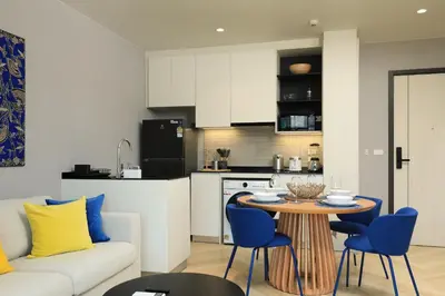 a living room with a couch and a table and chairs at 1BR Apartment with Mountain View near Bang-Tao Beach CapitalPro in Bang Tao Beach