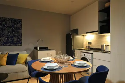 a kitchen and living room with a table and chairs at 1BR Apartment with Mountain View near Bang-Tao Beach CapitalPro in Bang Tao Beach