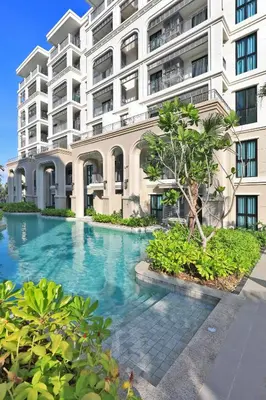 a building with a swimming pool in front of it at 1BR Apartment with Mountain View near Bang-Tao Beach CapitalPro in Bang Tao Beach