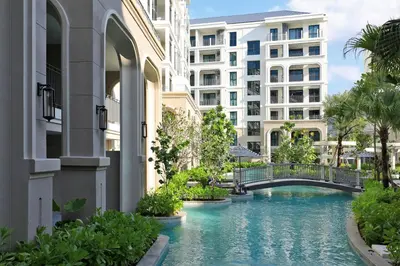 a pool in the middle of a building with a bridge at 1BR Apartment with Mountain View near Bang-Tao Beach CapitalPro in Bang Tao Beach