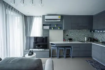 a kitchen with a couch and a table in a room at C252 Great Facility Condo Near Beach & Rooftop Pool in Kamala Beach