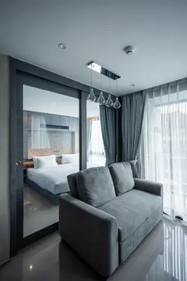 a living room with a couch and a bed at C252 Great Facility Condo Near Beach & Rooftop Pool in Kamala Beach