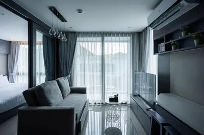 a room with a couch and a bed and a window at C252 Great Facility Condo Near Beach & Rooftop Pool in Kamala Beach