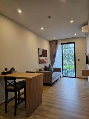 a living room with a couch and a table at Wora Phuket in Ban Sam Kong