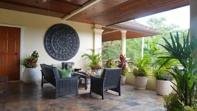 a patio with chairs and a table and potted plants at \u666e\u5409\u9ad8\u7aef\u5eb7\u517b\u6cf3\u6c60\u522b\u5885 in Layan Beach