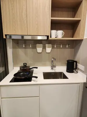 a kitchen with a sink and a stove and cabinets at Skypark Laguna Apartment with Rooftop Pool at Bang Tao Phuket in Laguna Phuket