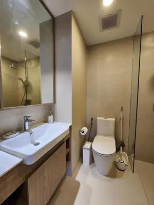 a bathroom with a sink and a toilet and a mirror at Skypark Laguna Apartment with Rooftop Pool at Bang Tao Phuket in Laguna Phuket