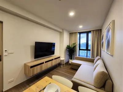 a living room with a couch and a flat screen tv at Skypark Laguna Apartment with Rooftop Pool at Bang Tao Phuket in Laguna Phuket
