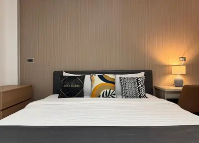 a bedroom with a bed with pillows on it at M2 Room For Rent in Patong Beach