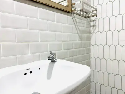 a bathroom with a white sink and a shower at M2 Room For Rent in Patong Beach