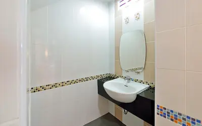 a bathroom with a sink and a mirror at Kiss Hometel in Ao Nang Beach