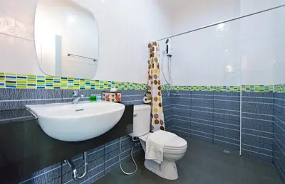 a bathroom with a sink and a toilet and a mirror at Kiss Hometel in Ao Nang Beach