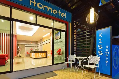 a store with three chairs and a table in the window at Kiss Hometel in Ao Nang Beach