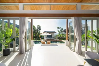 an internal view of the living room of a house at Luxury Royale Bangtao Pool Villa with maid in Thalang