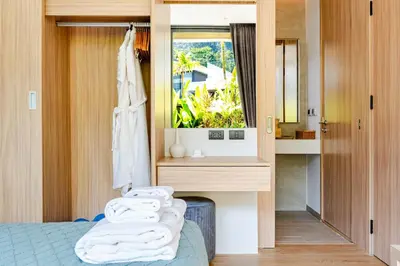 a room with a bed and a sink and a mirror at Aileen Naithon Hills - Tropical Haven Retreat in Nai Thon Beach