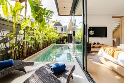an indoor swimming pool in a house with a bedroom at Aileen Naithon Hills - Tropical Haven Retreat in Nai Thon Beach