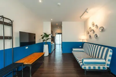 a living room with a couch and a table at Blu Monkey Boutique Naiharn - Serviced Apartments 1 Bedroom in Rawai Beach