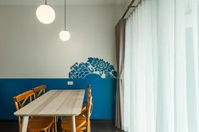 a dining room with a wooden table and chairs at Blu Monkey Boutique Naiharn - Serviced Apartments 1 Bedroom in Rawai Beach